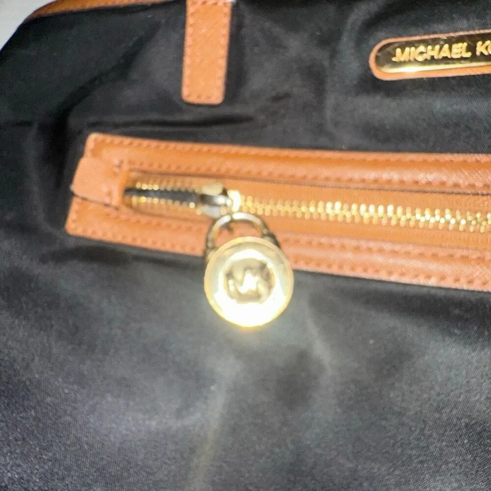 Michael kors black purse w/ tan trim 6 pockets